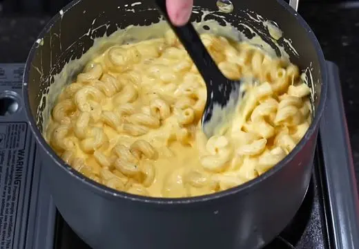 Combine Pasta with Cheese Sauce